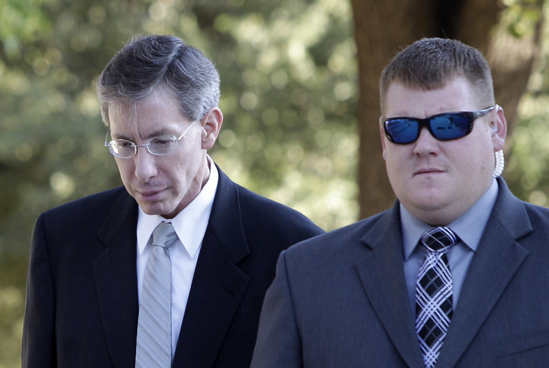 Sect leader Warren Jeffs, left, arrives at the Tom Green County Courthouse in San Angelo, Texas.