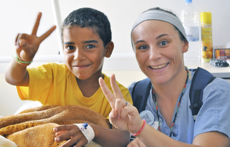 Sophie Belanger, a nurse from Maine Medical Center, poses with a young patient during an instructional visit at the Benghazi Medical Center in Libya.