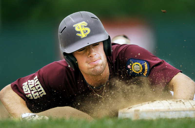 Sam Canales of Fayette-Staples dives safely back to first base during a 7-6 loss to Cranston, R.I., Friday in the American Legion Northeast Regional.