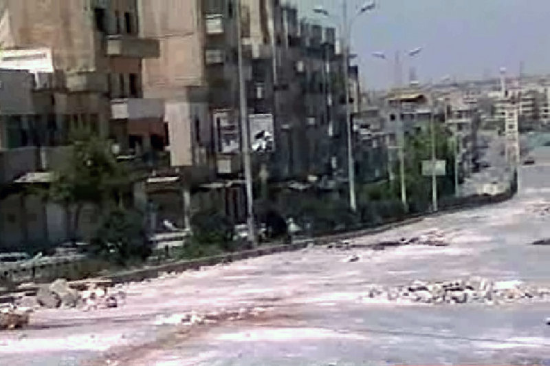 This image taken from television shows empty streets strewn with debris Thursday in the city of Hama, the Syrian center of many anti-Assad protests.