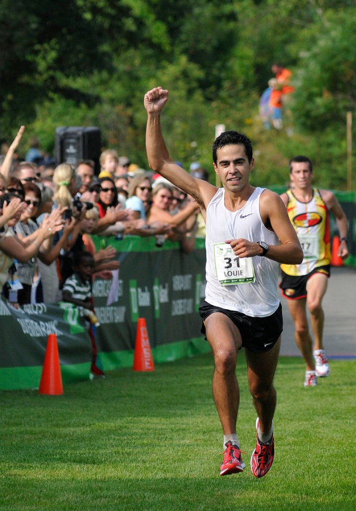 Louie Luchini of Ellsworth pumps his fist as he crosses the finish line at the Beach to Beacon 10K, winning the Maine men's division with a time of 30:35.