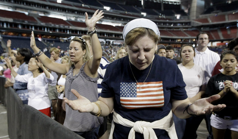 Lucy West of Killeen, Texas, prays at The Response, a call to prayer for a nation in crisis Saturday in Houston, Texas. Gov. Rick Perry attended the daylong prayer rally despite criticism that the event inappropriately mixed religion and politics.