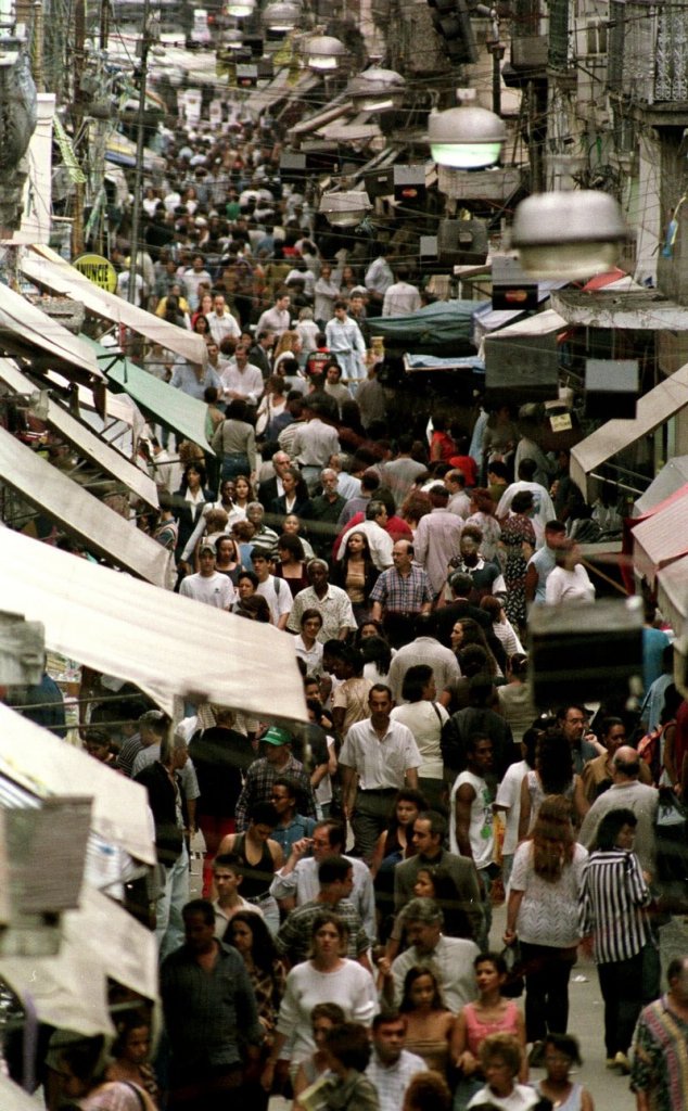 Shoppers fill a street closed to traffic in Rio de Janeiro, Brazil, where the middle class is growing. Multinational companies are investing in countries like Brazil, China and India in part because of their thriving consumer spending.