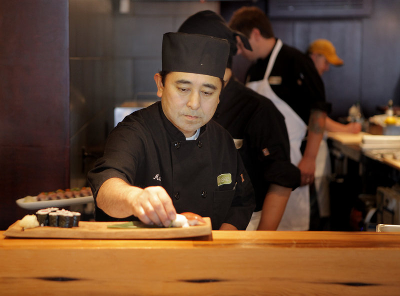 Chef Masa Miyake prepares lunch at his restaurant on Fore Street in Portland. This summer some of the food served at Miyake’s two restaurants has been produced at the farm behind his home in Freeport.