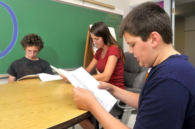 Logan Stout, 13, left, special education teacher Nicole Poole, center, and Travis Farr, 12, read parts in a play during the extended year Sebago Alliance program at the Frank Jewett School in Buxton.