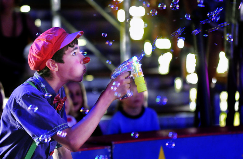 Sam Gurwitt of Norwich, Vt., blows bubbles during the Circus Smirkus show Monday at Rockin’ Horse Stables in Kennebunkport. The traveling circus, founded in 1987, gives children hands-on experience in the circus arts. The show continues today in Kennebunkport, then moves to Freeport on Thursday.