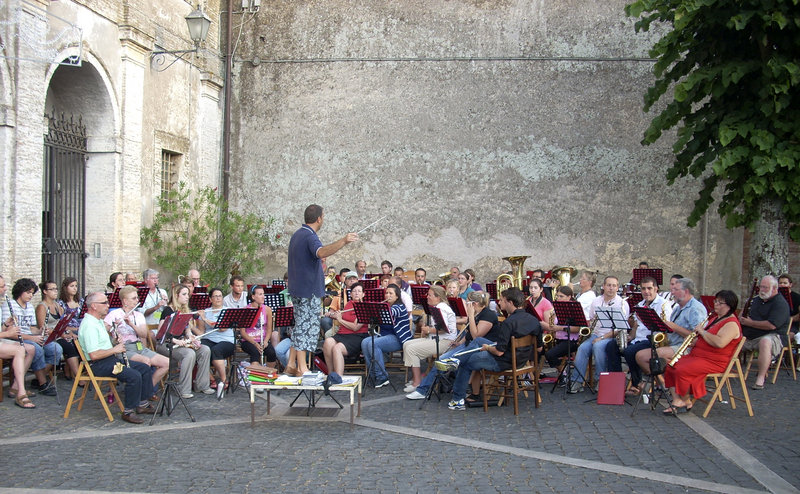 Members of the Portland-based Italian Heritage Center Band and La Banda Musicale Enrico Gai practice together in a square in Nepi, Italy, last year, conducted by Gianni Guiseppe Bannetta, director of the Nepi band.
