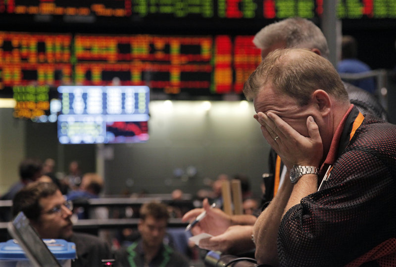 Trader Andrew Stavros reacts Monday at the close of trading in the Nasdaq pit on the floor of the CME Group in Chicago.