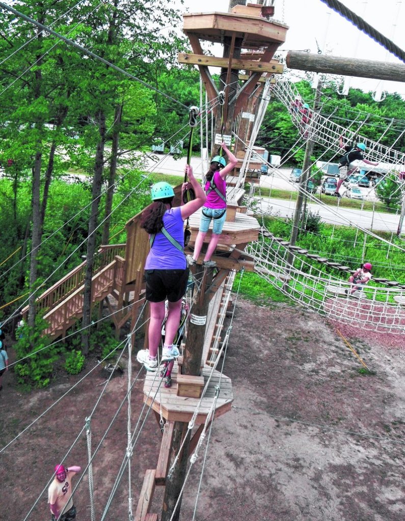 Tightrope crossings at Monkey Trunks in Saco take some balance, and grabbing pulley clips helps.