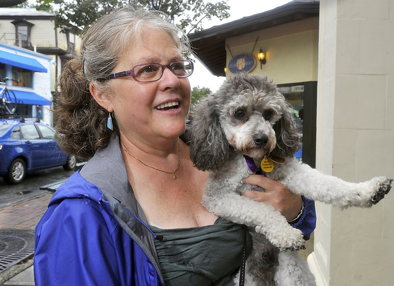 Claudia Rosti of Rhinebeck, N.Y., shops in Bar Harbor with her poodle Mazi Grace. Rosti says she came to visit the town and Acadia because her dog is welcome.