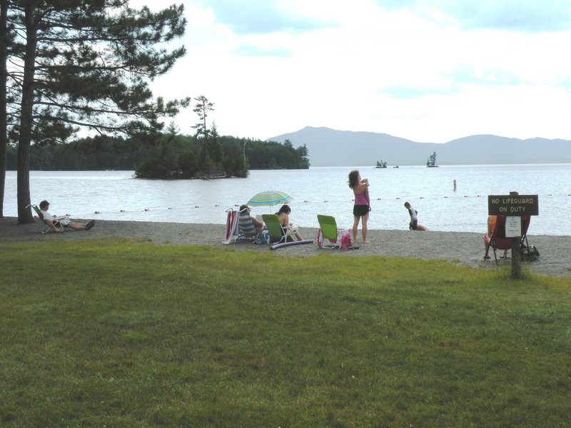 The beach at Lily Bay State Park looks across Moosehead Lake to Big Moose Mountain. The park offers camping, fine hiking trails and great wildlife watching.