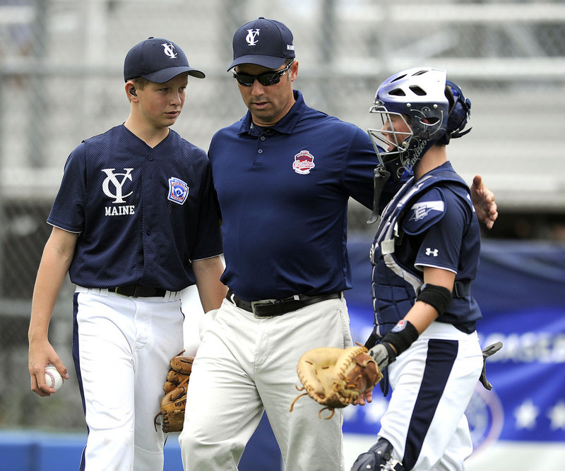 Yarmouth Manager Jay Tobias, center, meets at the mound with pitcher Luke Klenda and catcher Grant Tobias during Tuesday's game at the Little League regionals.