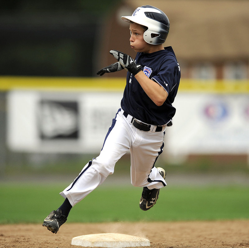 Jack Snyder of Maine champion Yarmouth rounds second and heads to third trying to stretch a double into a triple, but he was thrown out. Yarmouth lost 5-3 against Massachusetts Tuesday in the New England regional.