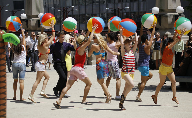 Actors dressed in beach attire participate in a flash mob as part of a commercial for McDonald’s in Chicago. Such events are now being organized for malicious purposes.