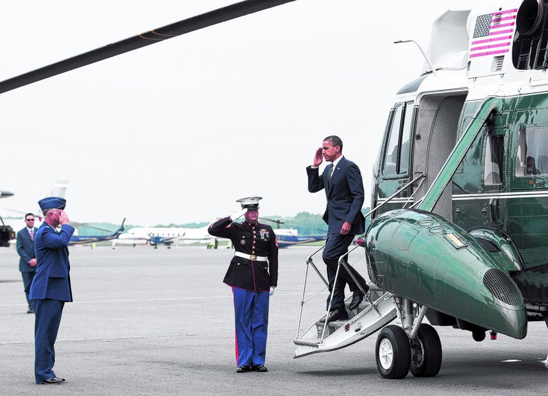 President Obama salutes Col. Mark Camerer, left, the 436th Airlift Wing Commander, as he steps off Marine One at Dover Air Force Base in Delaware on Tuesday.