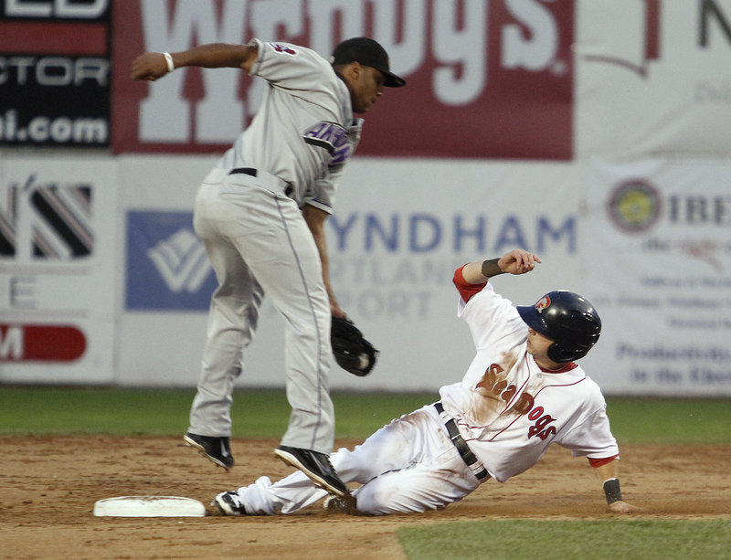 Ryan Khoury of the Portland Sea Dogs slides under the tag of Akron second baseman Karexon Sanchez to collect a stolen base in the third inning Wednesday night.