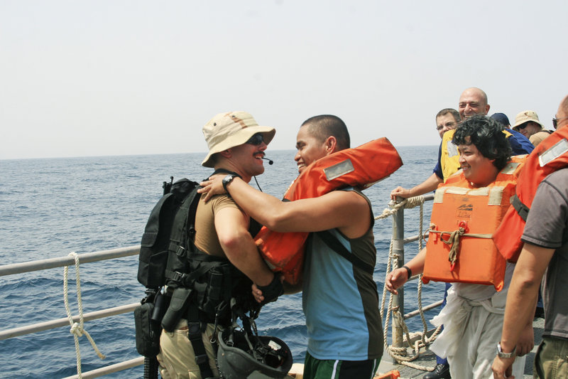 Lucas Alderette, left, of the USS Philippine Sea says goodbye to a sailor rescued from the tanker Brillante Virtuoso last month in the Gulf of Aden.