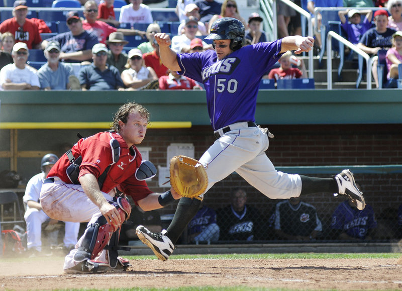 Raul Padron of the Akron Aeros strides to the plate Thursday as catcher Matt Spring of the Portland Sea Dogs awaits the throw during Akron's 13-5 victory at Hadlock Field.