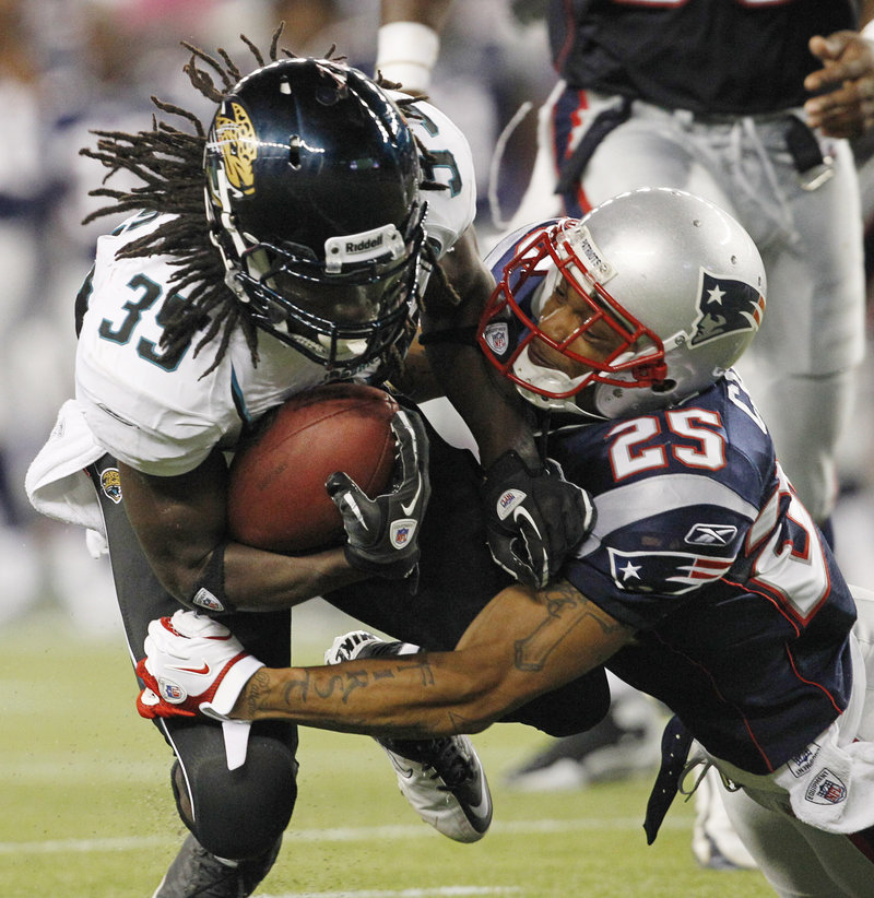 Jacksonville Jaguars running back Deji Karim, left, gets a hearty welcome from New England Patriots safety Pat Chung in the second quarter of their NFL preseason game in Foxborough, Mass., on Thursday night. The Patriots' backup quarterbacks looked impressive in the team's 47-12 victory.