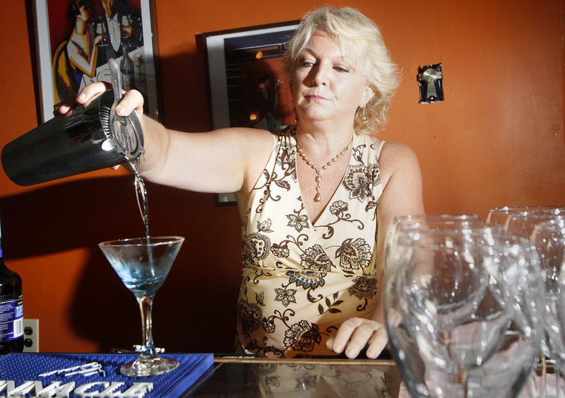 Deb Haggerty pours a blueberry martini at Jonathan's. The restaurant-bar's signature drink is the elderberry martini.