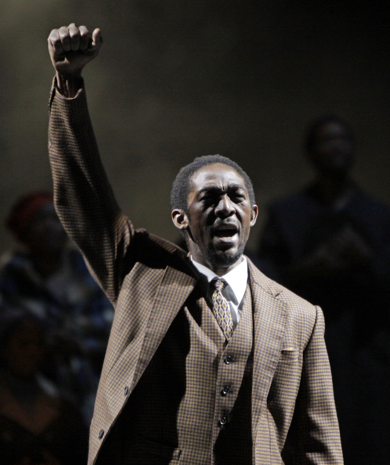 Aubrey Lodewyk plays Nelson Mandela giving a black power salute at the end of Mandela’s treason trial during a dress rehearsal of the new opera “Mandela Trilogy” in Johannesburg on Friday.