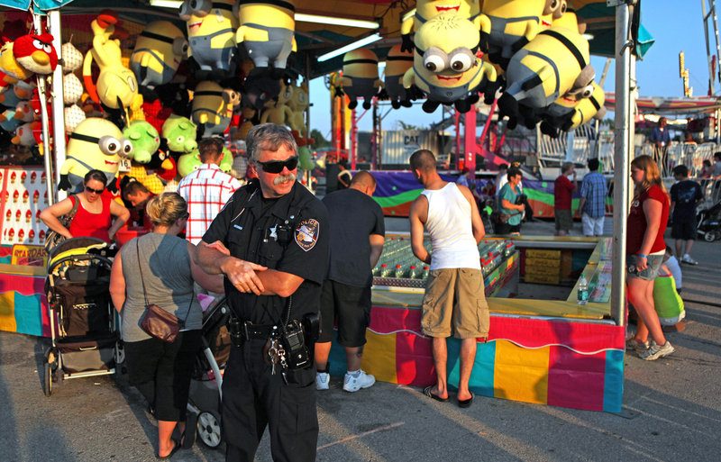 Extra law enforcement officers patrol the Wisconsin State Fair last week because of recent mob attacks at a fair in West Allis, Wis. On the opening night of that fair, 31 people were arrested and at least 11 people were hurt.