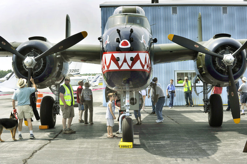 Veterans and children are among visitors examining a World War II-era B25 bomber at the Wiscasset Municipal Airport on Saturday. The six planes are maintained and flown by The Texas Flying Legends, a nonprofit group that is considering creating a summer base in Maine for its extensive collection.