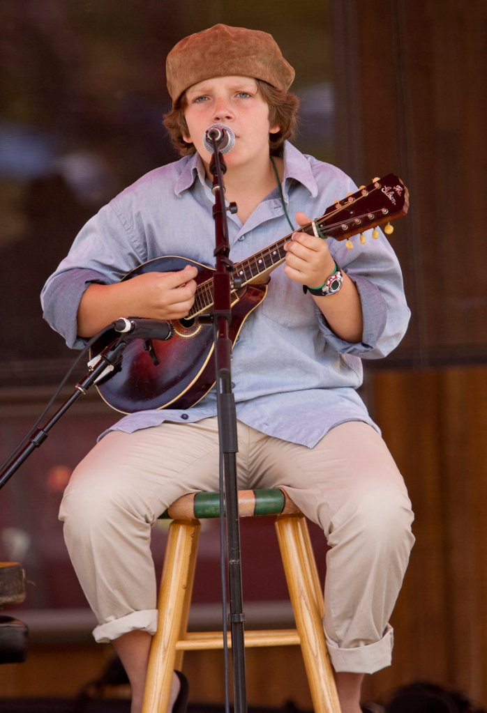 Mason Strunk, 12, grandson of the late singer-songwriter Jud Strunk, performs on Saturday.
