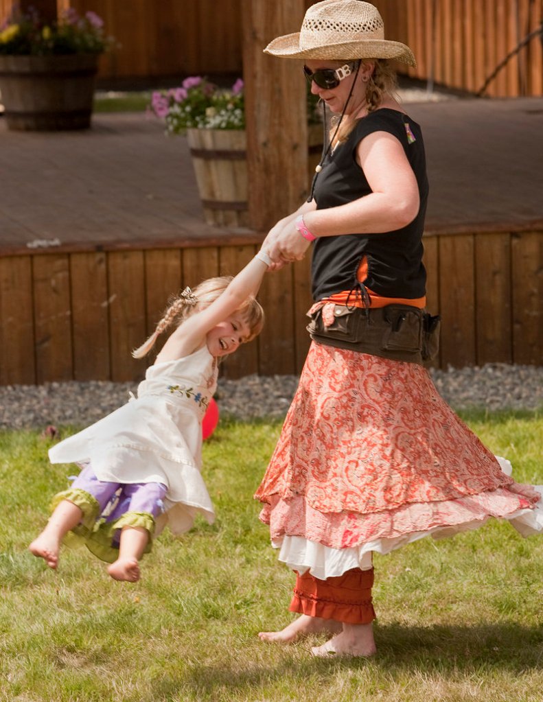 Christine Stout of Jefferson swings her 3-year-old daughter Jade while dancing to a tune at the Saddleback Mountain Bluegrass Festival.
