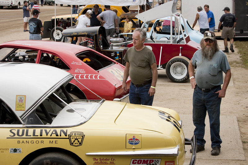 Darrell Flanders of New Gloucester and Joe Espeaignette of Windham check out cars on display at Sunday's Maine Vintage Race Car Association event.