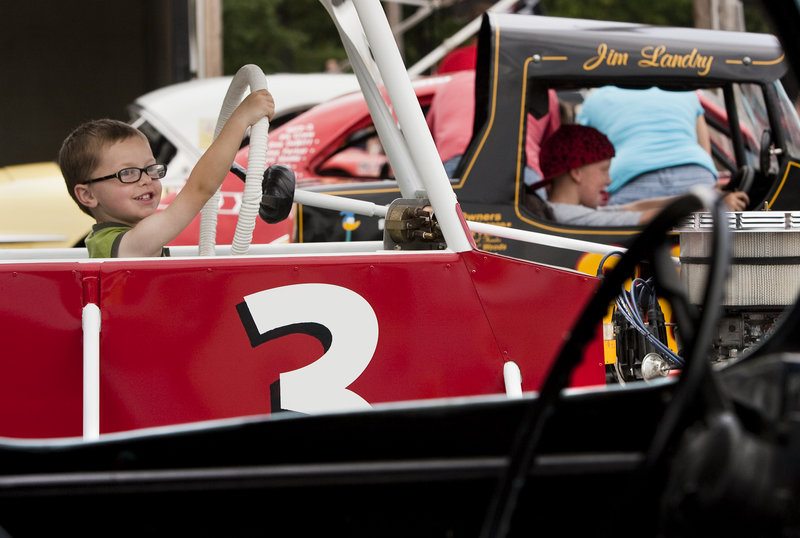Sam Rondeau, 3, of Saco pretends to drive his grandfather's car during the Maine Vintage Race Car Association gathering at Beech Ridge Motor Speedway in Scarborough on Sunday.