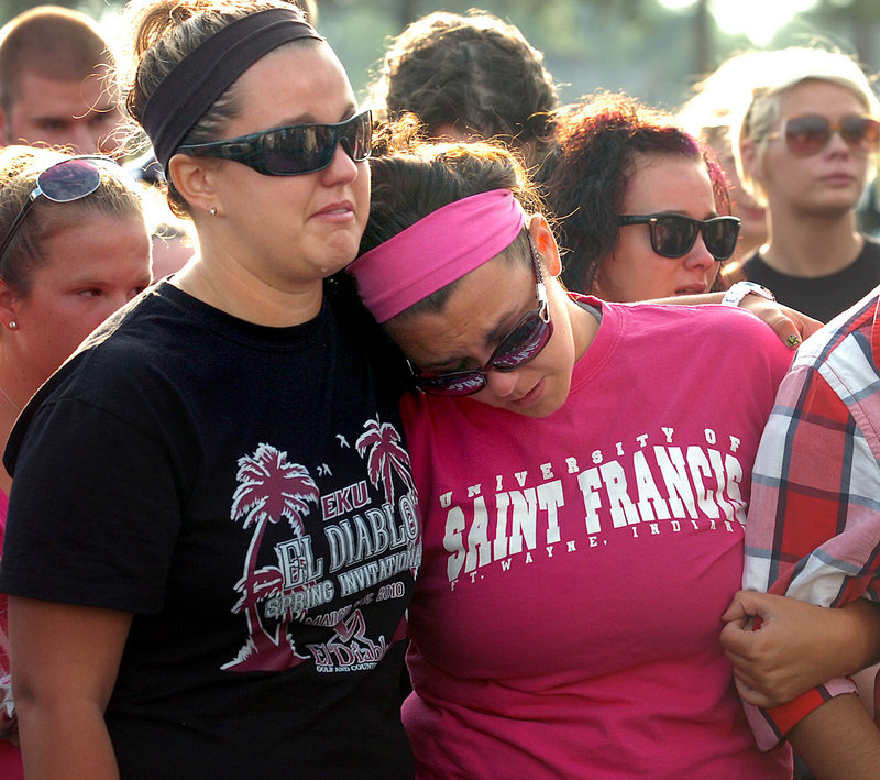 Nikki LeRose, left, and Kelsea Jackson remember their friend Alina Bigjohny at a memorial gathering at Wayne High School in Fort Wayne, Ind., on Sunday. Bigjohny, 23, a 2007 graduate of Wayne, was killed Saturday night in the stage collapse at the Indiana State Fair.