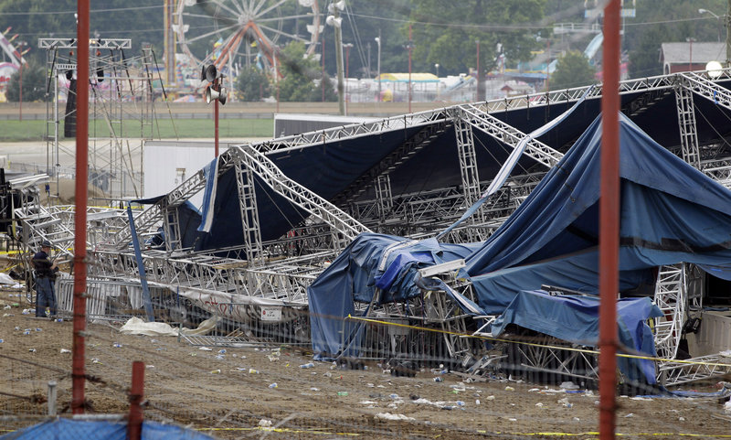 Indiana authorities survey the collapsed rigging and stage on the infield at the Indiana State Fair in Indianapolis on Sunday. Five people died in the stage collapse.