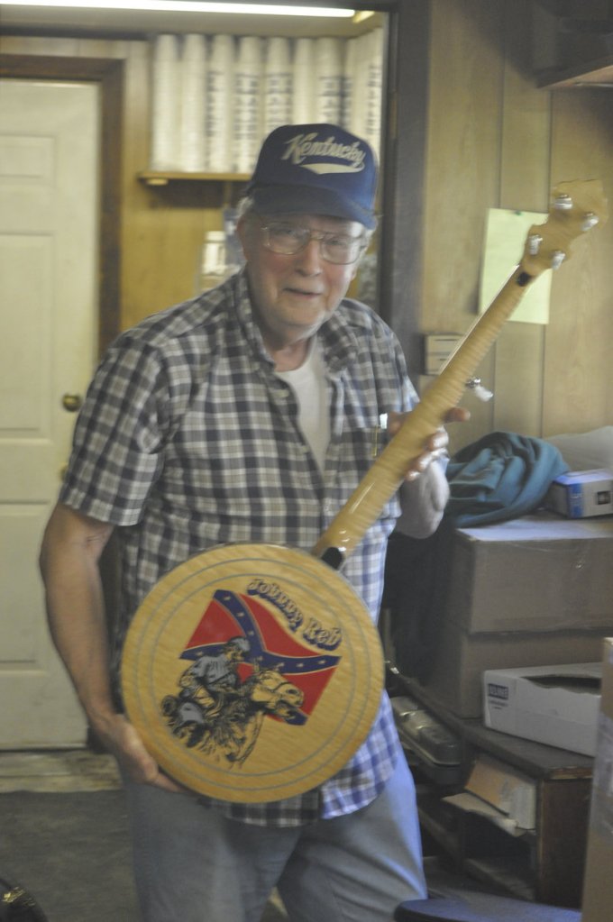 Jimmy Cox holds one of his hand-made Johnny Reb banjos. He made a limited edition of 20, one for each commander in the Confederate Army.