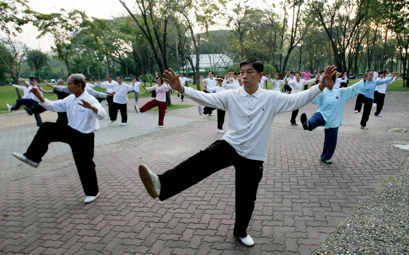 Men and women practice martial arts in Bangkok, Thailand. Regular exercise builds muscles, reduces the risk of some diseases and promotes mental well-being.
