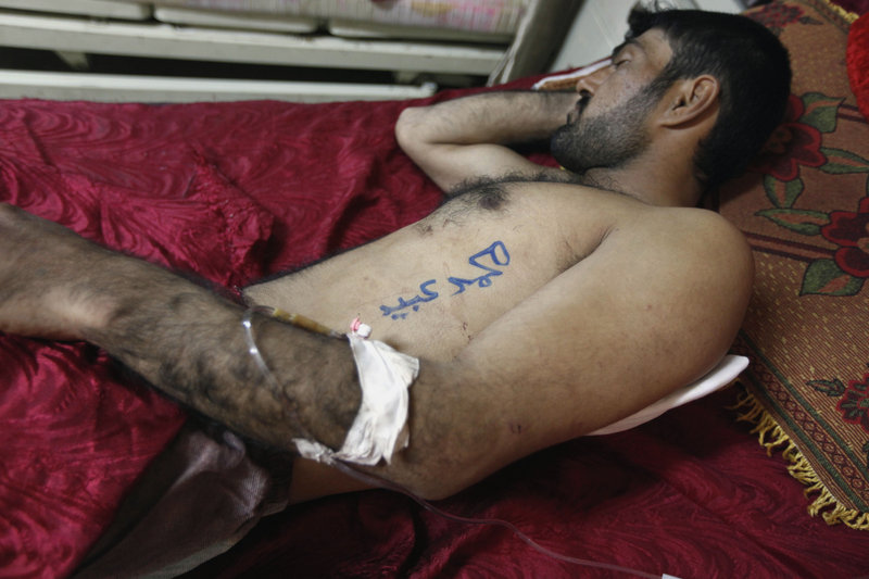 Mohammed Odeid lies injured in a hospital bed, with his name written on his body in Arabic, after a car bomb detonated Monday in Kut, Iraq. It was one of numerous coordinated attacks, apparently the work of al-Qaida in Iraq, in 17 cities spanning nine provinces.