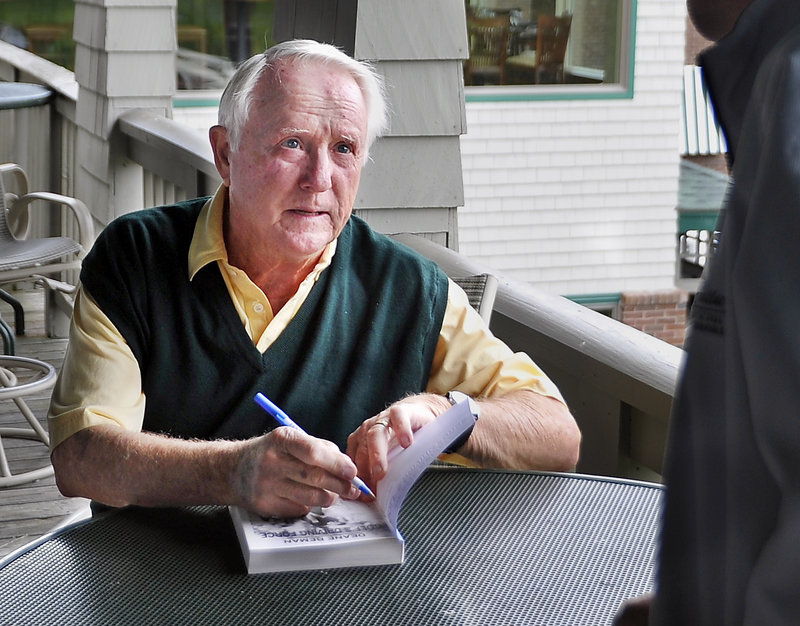 Deane Beman, a former PGA Tour chief, signs copies of his book Monday in Falmouth for participants at a fundraiser for the First Tee of Maine program.