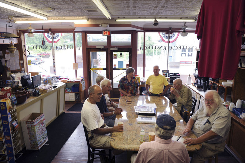 Eight local residents hold court at Frisbee’s Market in Kittery Point on a recent Sunday morning. Clockwise from back left, they are Sandra Rux, Steve Kehl, Richard Raynes, Fred Blader, Rich Barbieri, Bruce Williams, Ben Potter and Al Farrah. The coffee klatsch only recently began meeting again after a long hiatus when the store underwent some changes.
