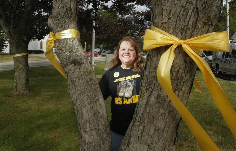 Susan Babb-McKinney wants to keep putting yellow ribbons on village green trees, but Alfred selectmen may decide to limit the practice.