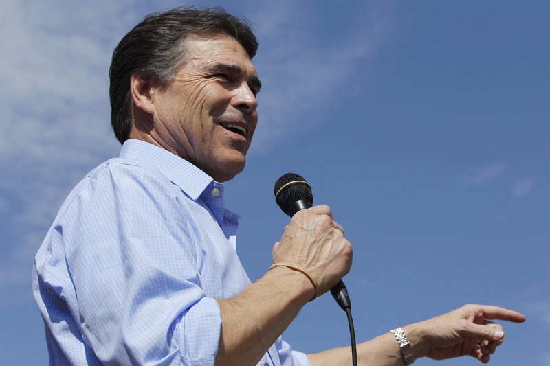 Texas Gov. Rick Perry speaks at the Iowa State Fair on Monday. To the national electorate, his style may be too much like another blunt Texan: former President George W. Bush.