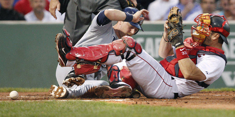 Red Sox catcher Jason Varitek fails to hold onto the ball as Ben Zobrist of the Tampa Bay Rays slides safely home to score on Sean Rodriguez’s grounder in the nightcap.