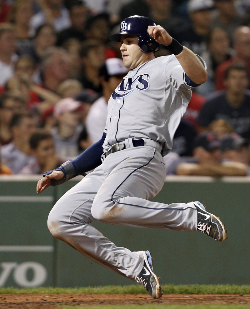 Evan Longoria of the Tampa Bay Rays slides into home to score on B.J. Upton’s single Tuesday night in the eighth inning of the second game against the Boston Red Sox.