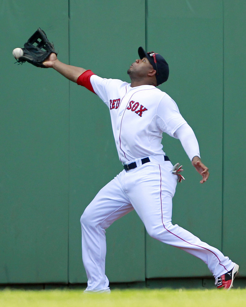 Carl Crawford of the Boston Red Sox just misses a foul ball down the left-field line hit by Desmond Jennings of the Tampa Bay Rays during the Rays’ 4-0 victory at Fenway Park.