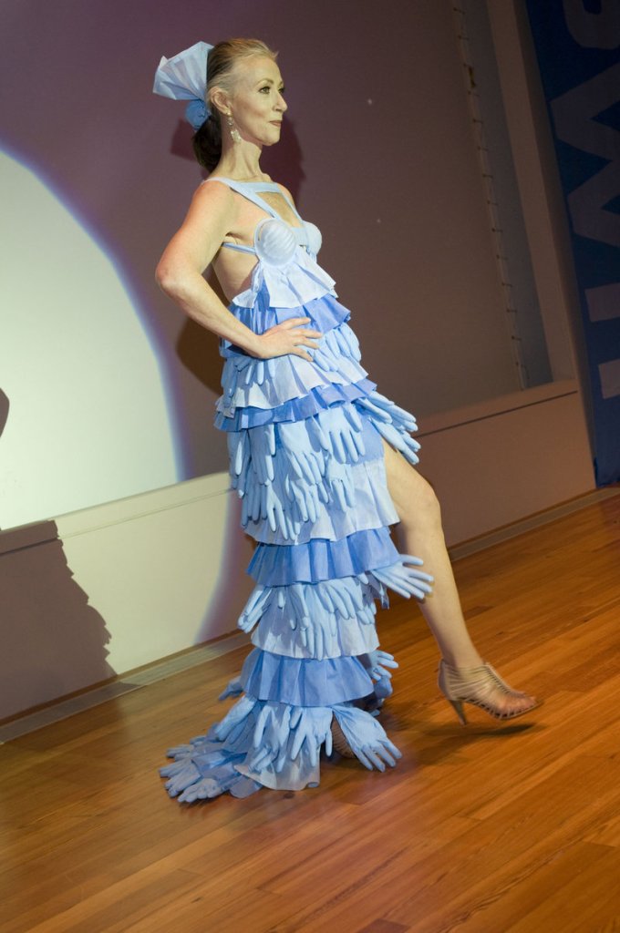 Mardie Weldon’s dress of blue surgical gloves interlaced with blue wrap features a long-tailed skirt with a very short front and strategically placed blue surgical masks.