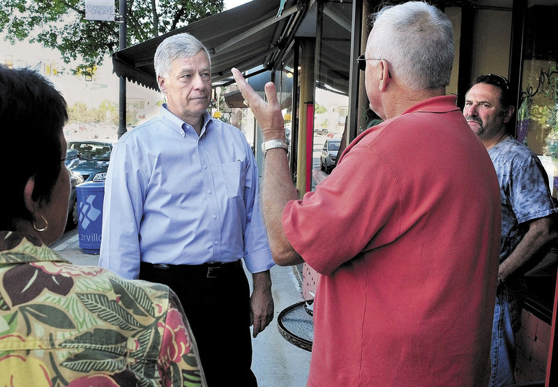 U.S. Rep. Mike Michaud, D-2nd District, center, speaks with Kelly Wynn, left, and Marc Bizier during a walking tour in downtown Waterville on Wednesday. Michaud spoke with many people regarding the need to redraw boundaries for the state's two congressional districts.