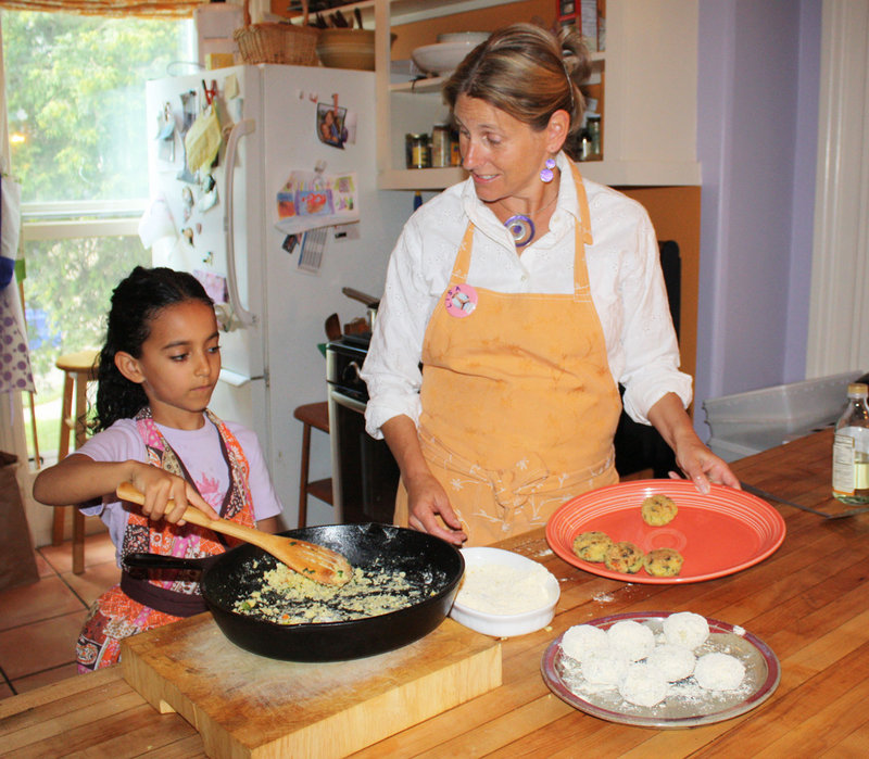 With help from her young friend Hana LaPaz Wallen, Lisa Silverman makes macrobiotic millet croquettes in the kitchen of the Five Seasons Cooking School.