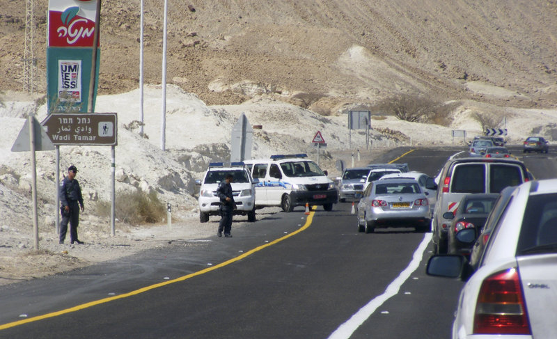 Vehicles straddle a security roadblock after a shooting attack along the border between Israel and Egypt.