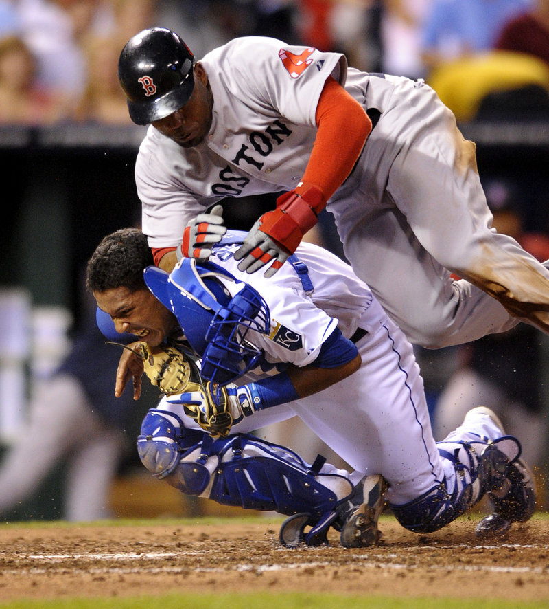 Kansas City catcher Salvador Perez holds on for the out Thursday night as Carl Crawford of Boston tries to score from third on a fly ball by Mike Aviles.