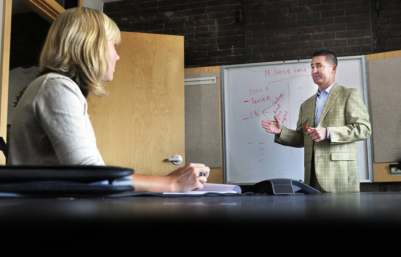 CEO Brian Corcoran meets with staff at Shamrock’s offices on Commercial Street. His sports and entertainment marketing firm has eight employees now and he plans to add two to four staff members by early 2012.