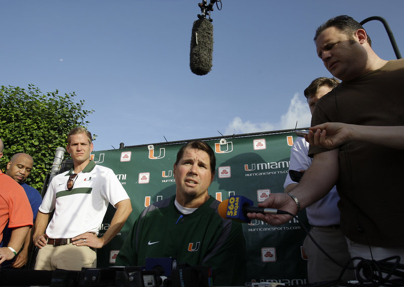 Al Golden, center, the Miami football coach, can only wait and see what will happen to his program in the wake of allegations of improper benefits over an eight-year period.